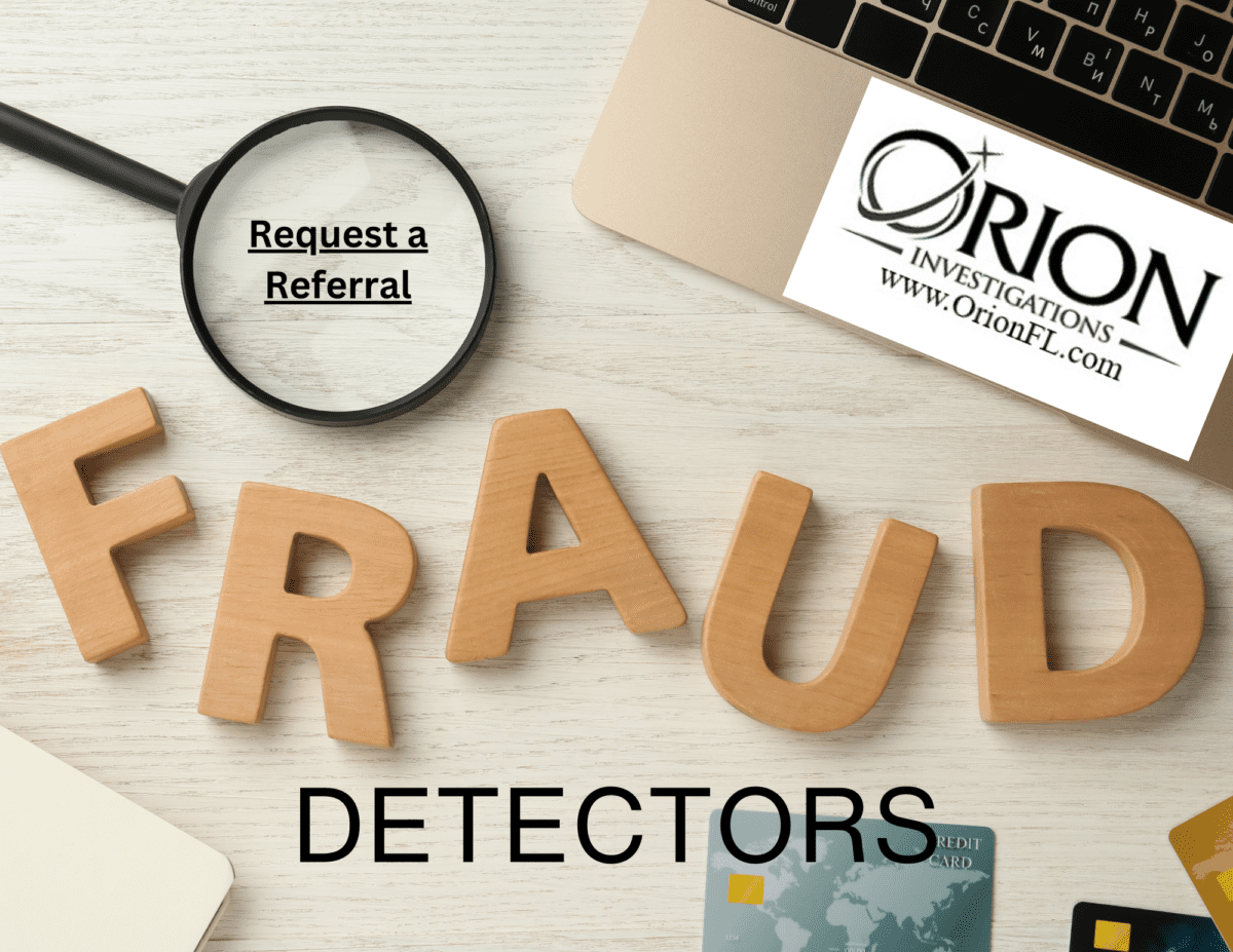 Wooden letters spelling FRAUD with laptop and cards